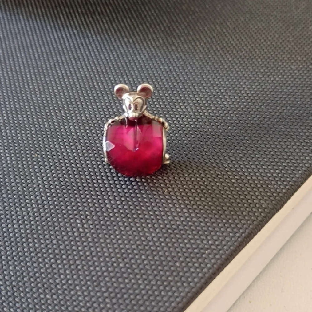 Pandora Disney Mickey Mouse Heart charm featuring a fuchsia crystal.